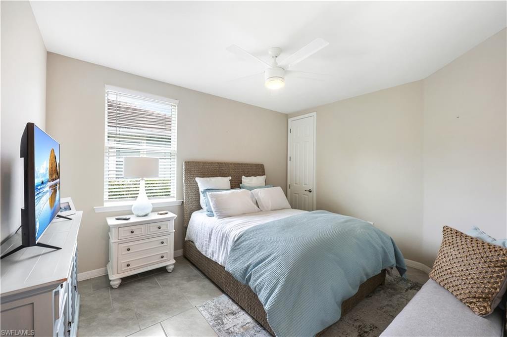 Bedroom featuring light tile patterned floors and ceiling fan