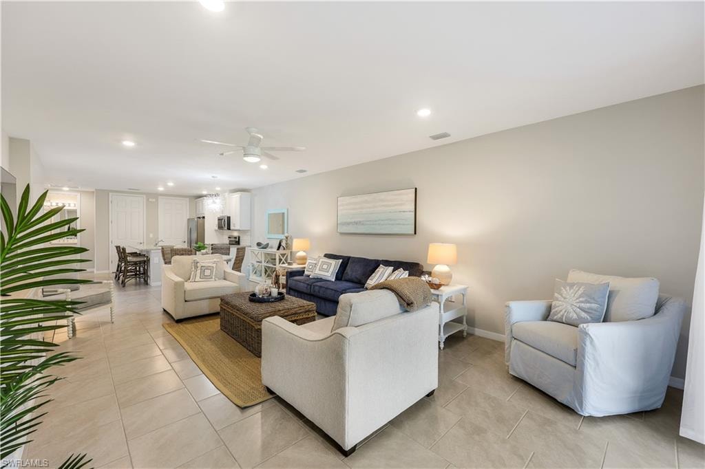 Living area featuring recessed lighting, ceiling fan, and light tile patterned floors