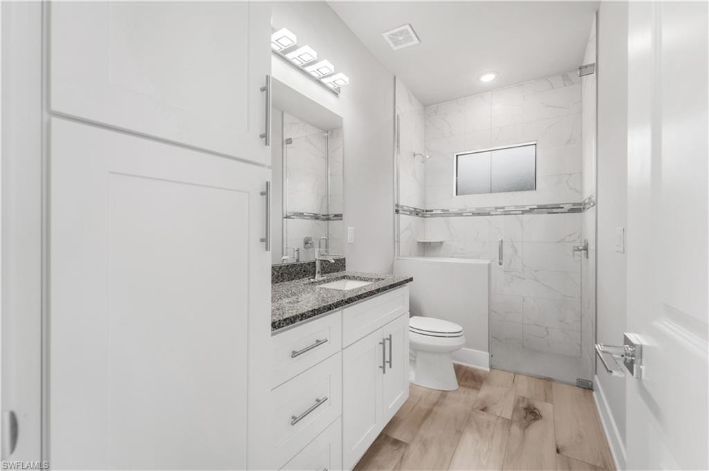 Pool Bath with vanity, visible vents, recessed lighting, toilet, and a marble finish shower