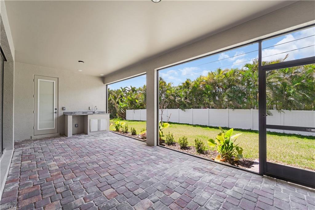 Unfurnished sunroom with a sink and area for grilling