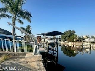 Dock with a water view and boat lift