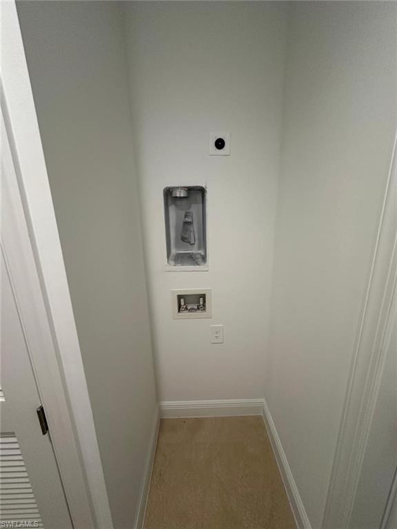 Laundry area with light colored carpet, washer hookup, and electric dryer hookup