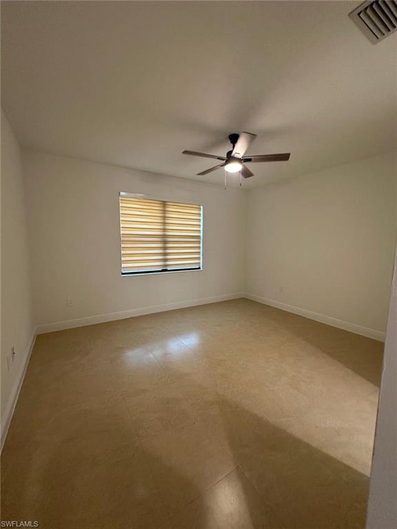 Unfurnished room with baseboards and ceiling fan