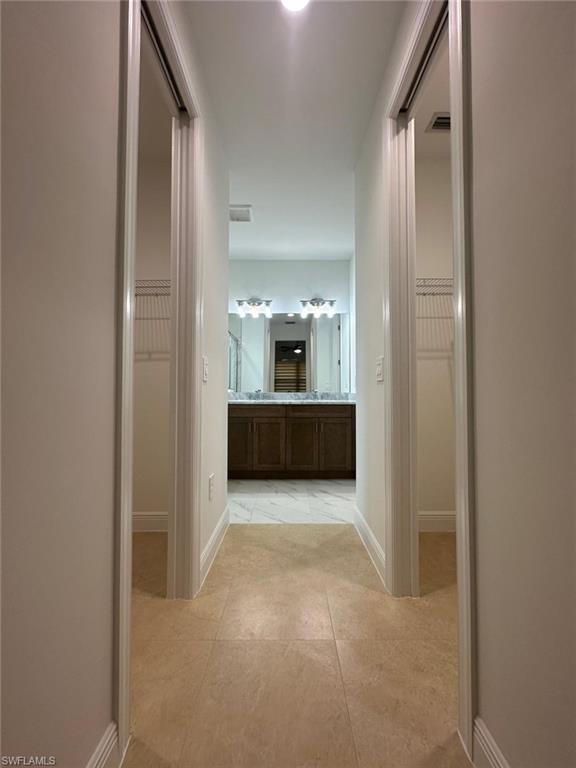 Hallway featuring baseboards