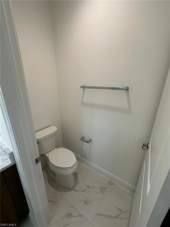 Bathroom featuring light marble finish flooring and vanity