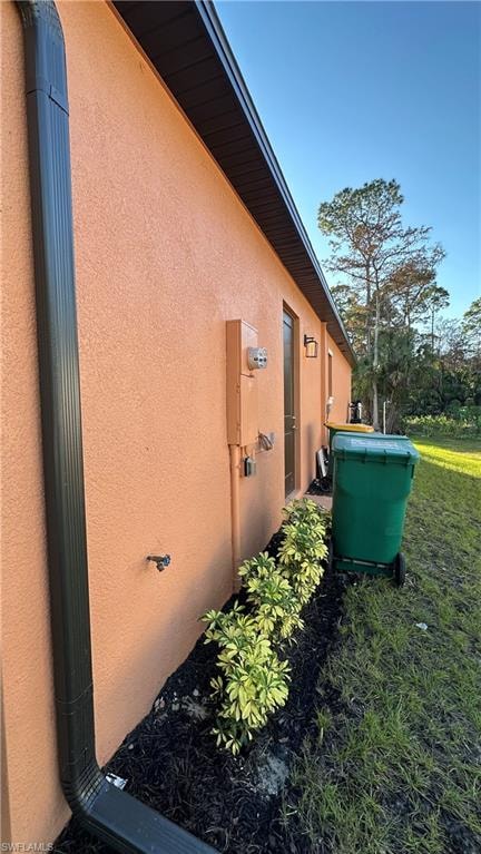 View of side of home featuring stucco siding