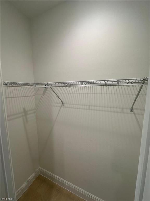 Spacious closet featuring light tile patterned flooring