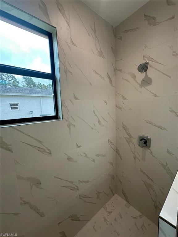 Bathroom featuring a tile shower