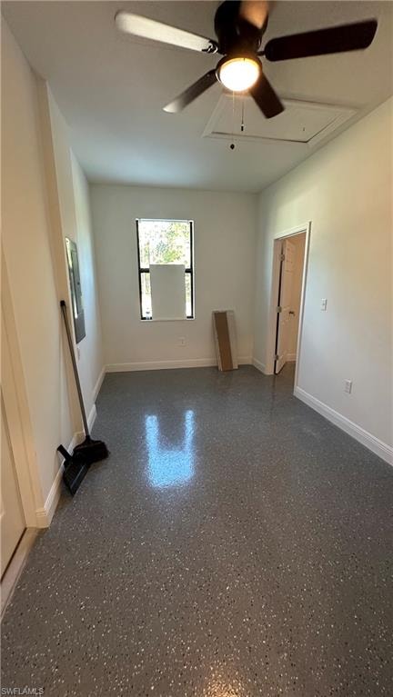 Spare room with ceiling fan and baseboards