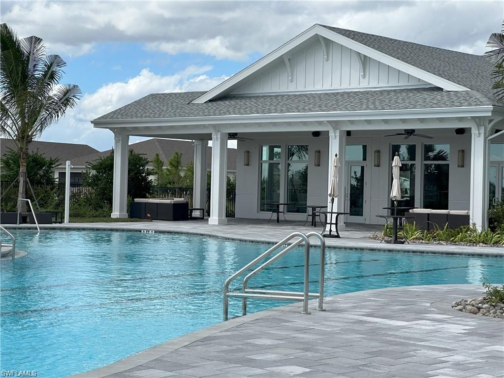 Community pool featuring a ceiling fan and a patio