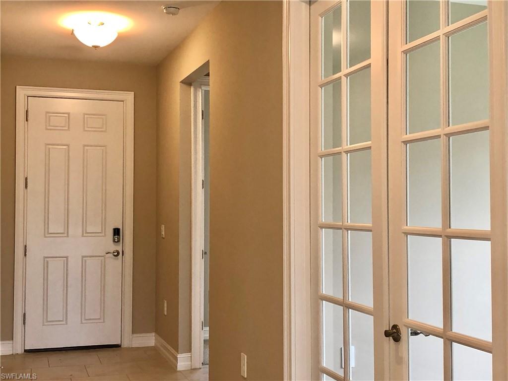 Kitchen with backsplash, white cabinets, stainless steel appliances, a kitchen island with sink, and a breakfast bar area