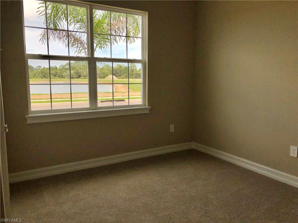 Empty room featuring a chandelier, light tile patterned floors, and recessed lighting