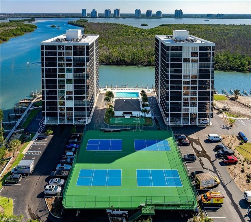 View of urban area with apartment complex / building and a nearby body of water