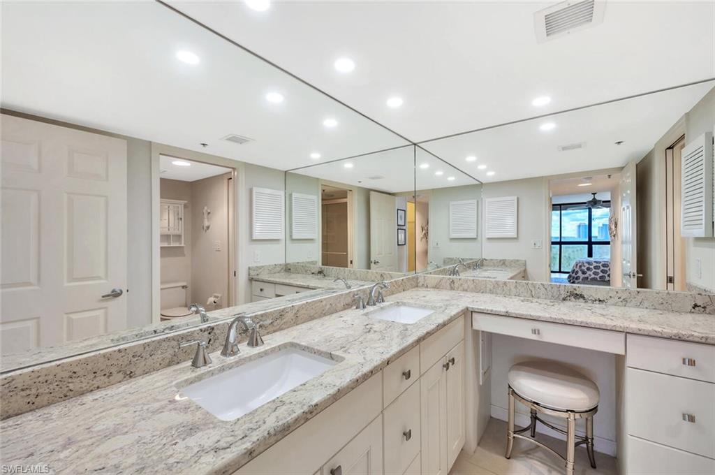 Ensuite bathroom featuring double vanity and recessed lighting