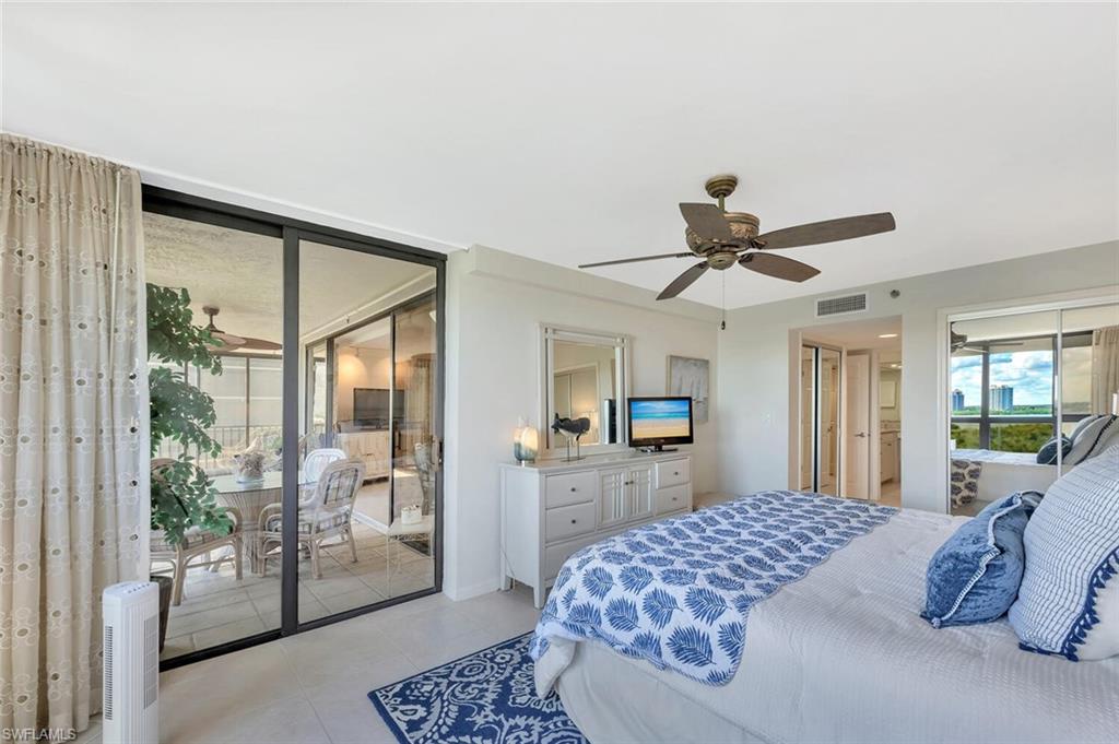 Tiled bedroom featuring access to outside and a ceiling fan