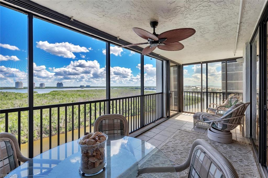 Sunroom with a water view, ceiling fan, and outdoor dining area