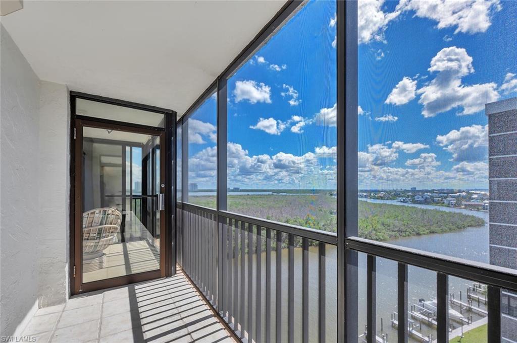 Balcony with a sunroom and a water view