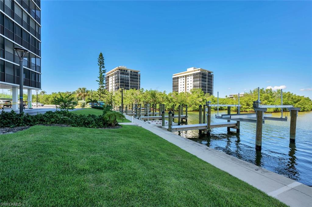 Dock area featuring a yard, a water view, and boat lift