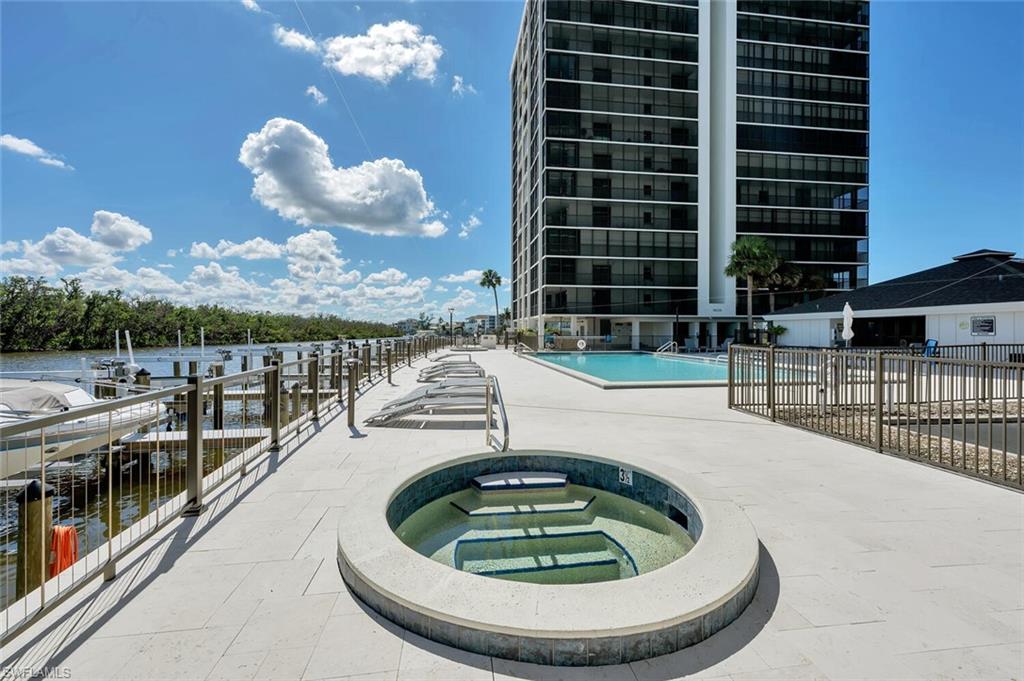 Community pool featuring a community hot tub and a patio