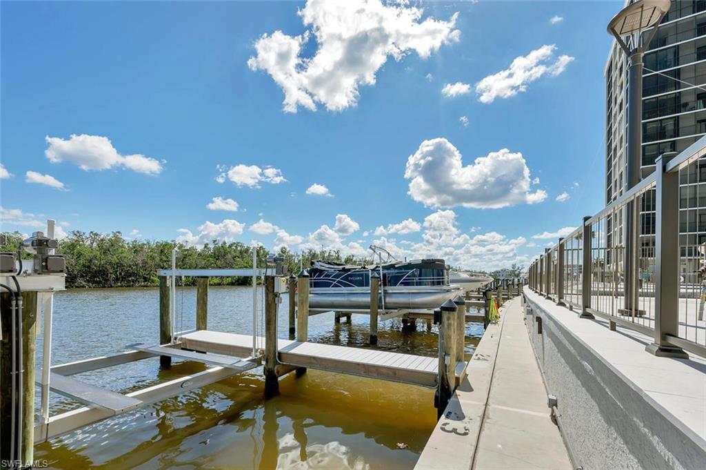 Dock area featuring boat lift and a water view