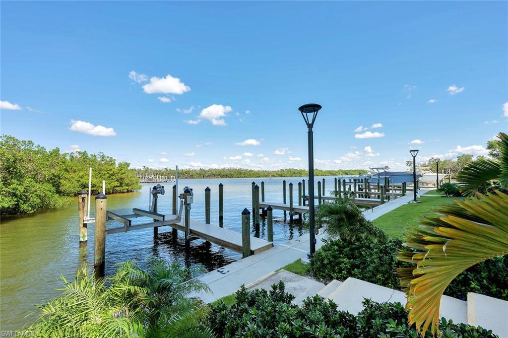 Dock area featuring boat lift and a water view