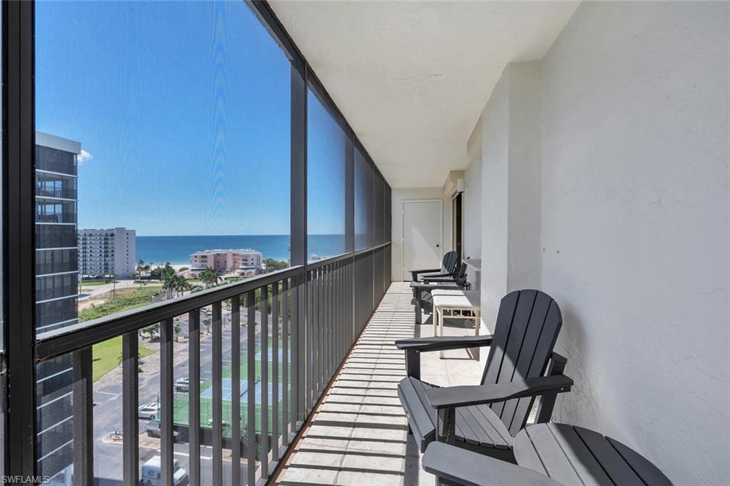 Balcony featuring a sunroom and a water view