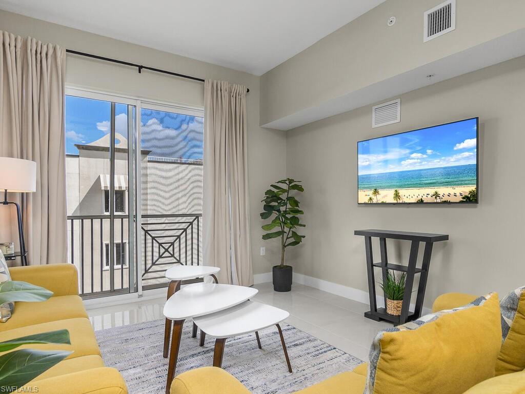 Living Room features tiled flooring, access to the lanai, comfortable space offered "Turnkey"