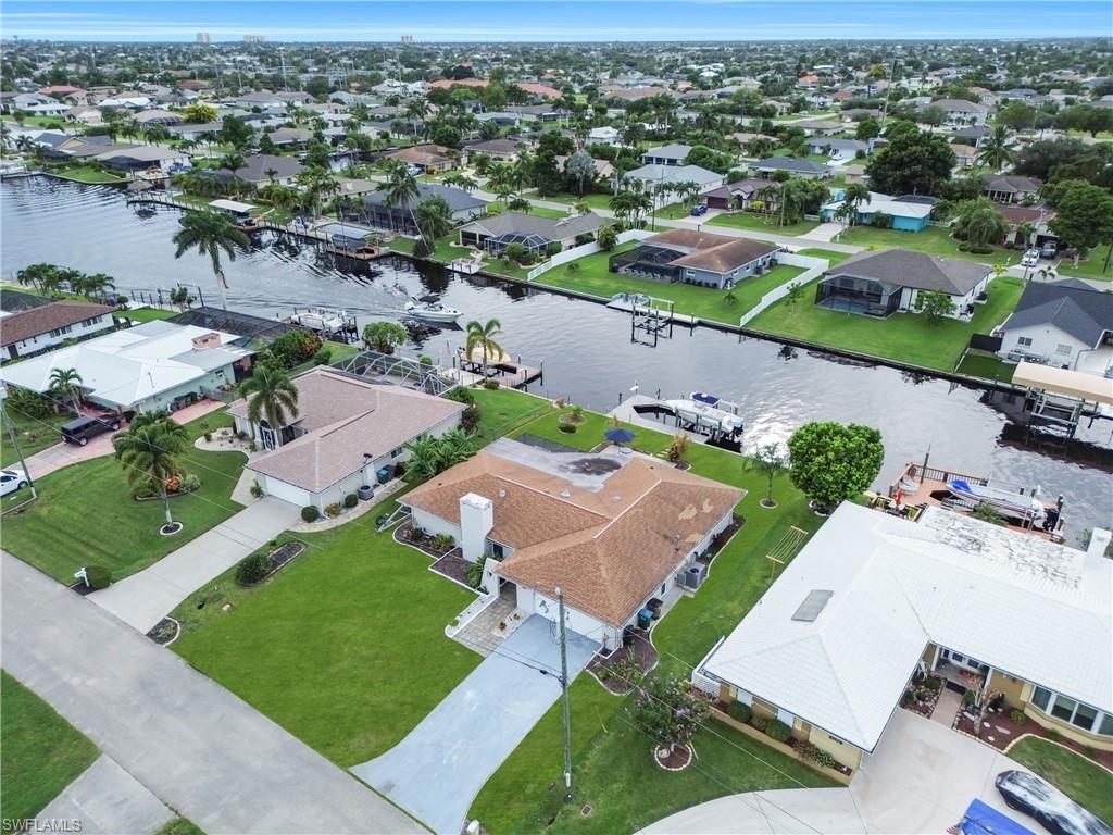 Aerial view of residential area featuring a nearby body of water
