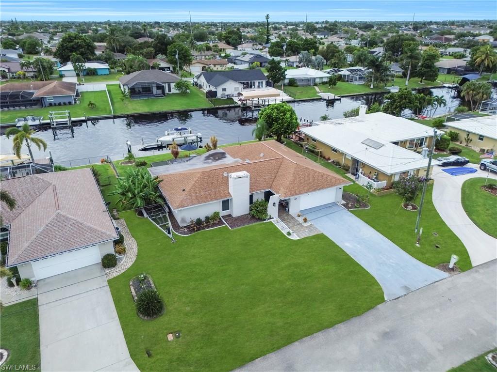 Aerial view of residential area featuring a nearby body of water