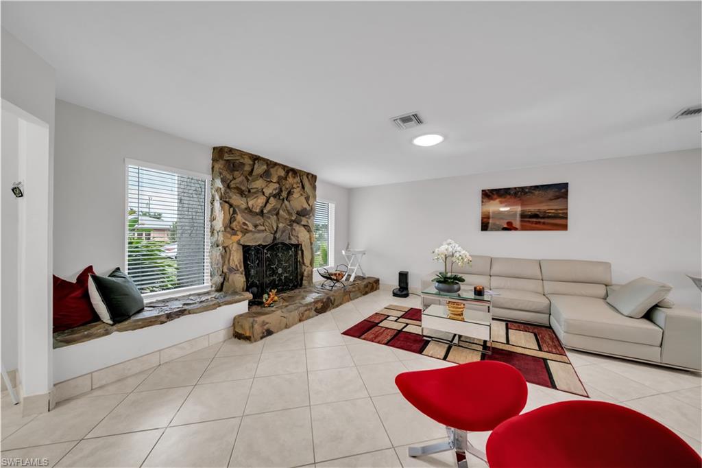 Living room featuring tile patterned floors and a fireplace