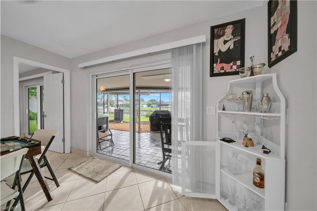 Entryway with tile patterned floors and a sunroom