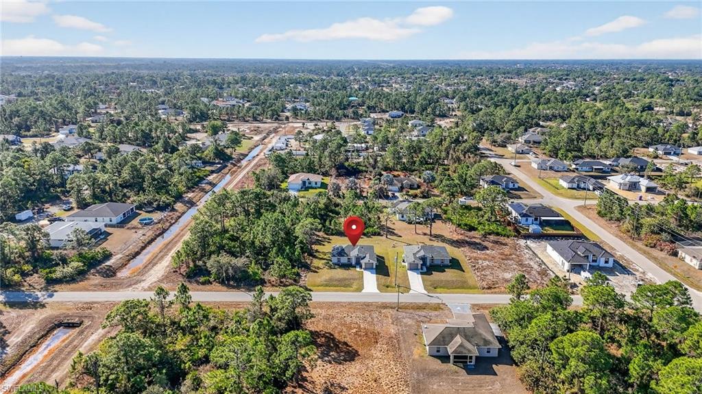 Aerial view of property's location with nearby suburban area