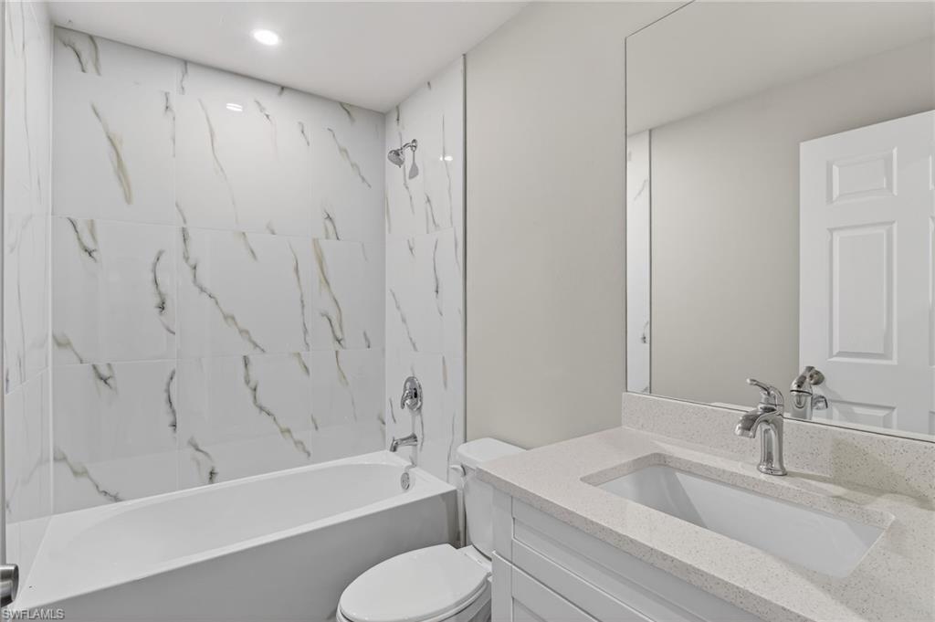 Bathroom with vanity and shower / tub combination