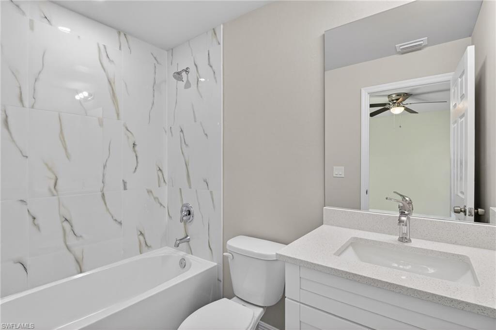 Bathroom featuring vanity and  shower combination