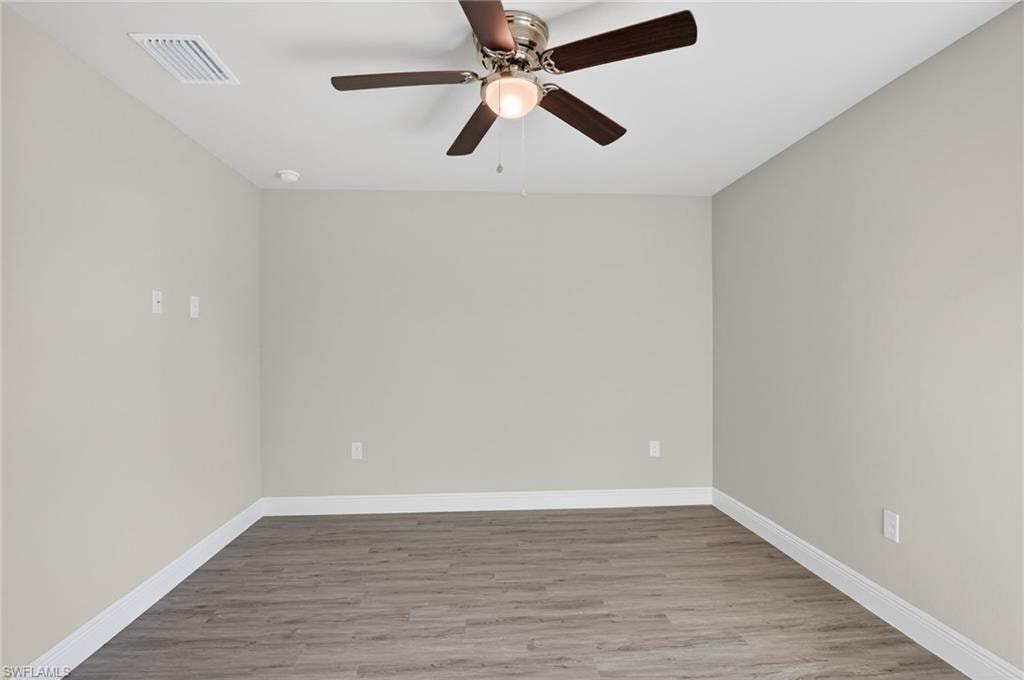 Empty room with light wood-type flooring and a ceiling fan