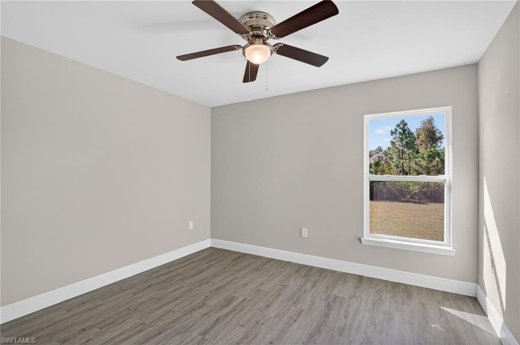 Unfurnished room featuring light wood-style floors and a ceiling fan