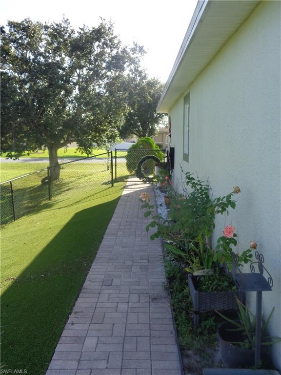 View of the side of the property featuring a gate