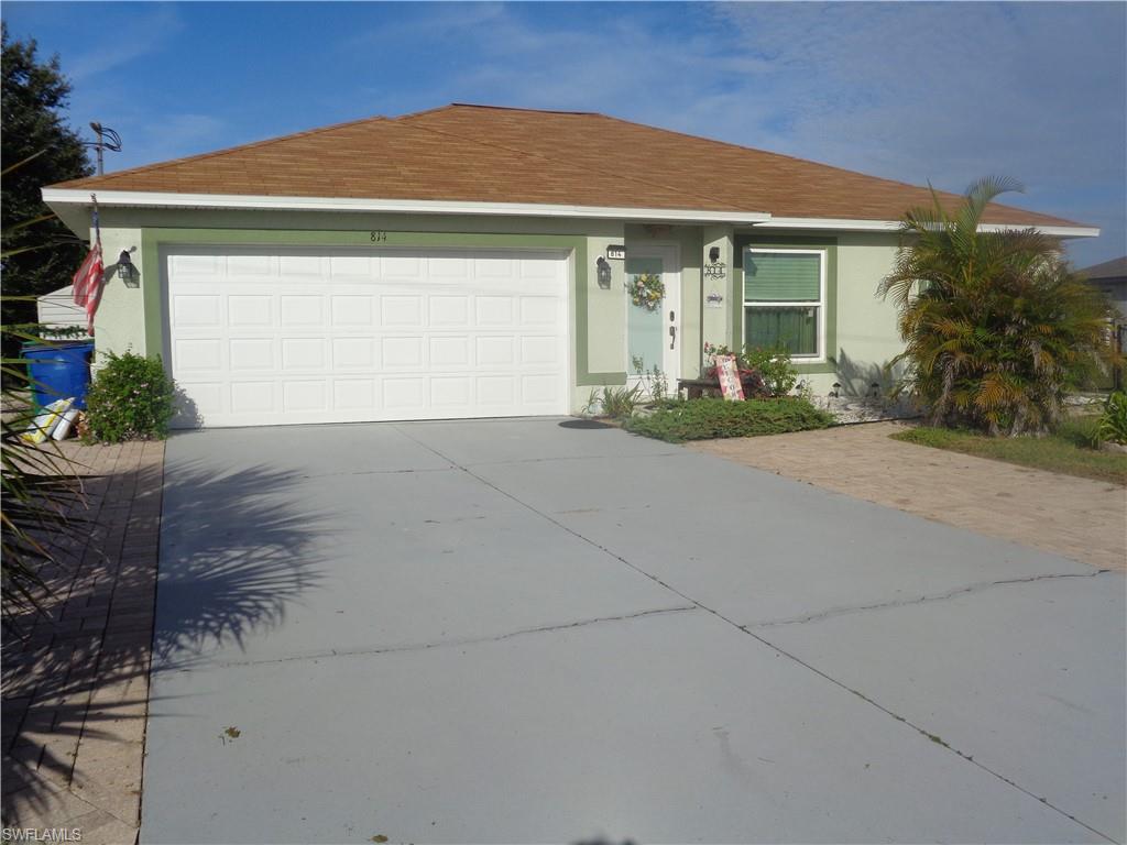 Ranch-style house featuring stucco siding, driveway, roof with shingles, and a garage