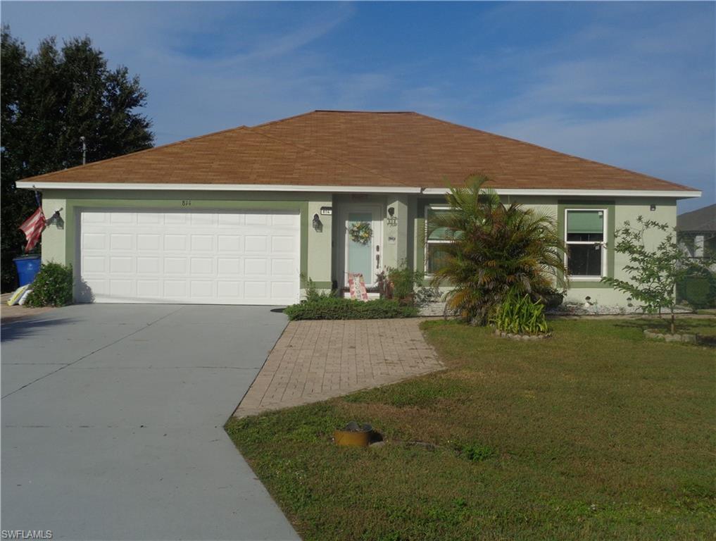 Ranch-style home with stucco siding, a front lawn, concrete driveway, and roof with shingles