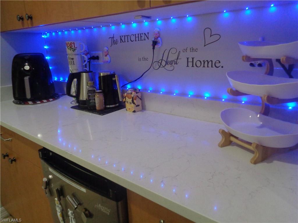 Cabinet area featuring light stone countertops, brown cabinets, and dishwasher