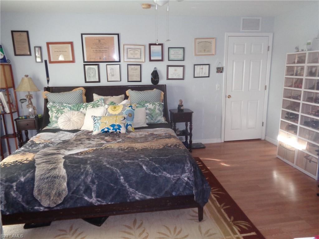 Bedroom featuring wood finished floors and a ceiling fan