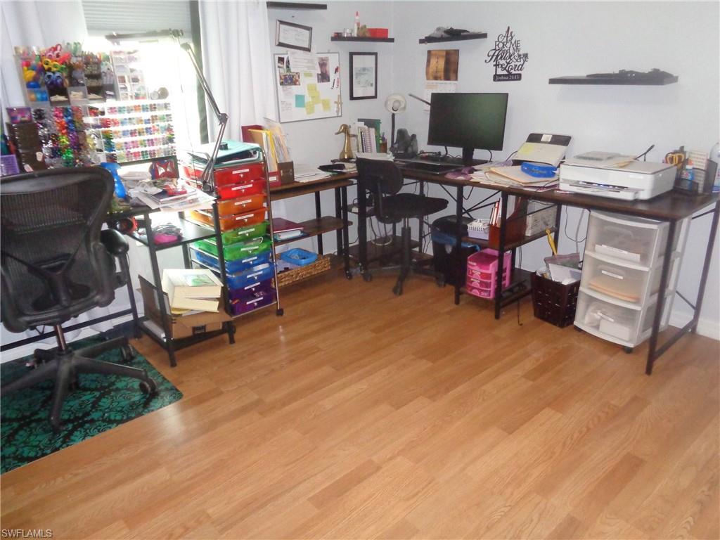 Bedroom turned into office featuring light wood-type flooring