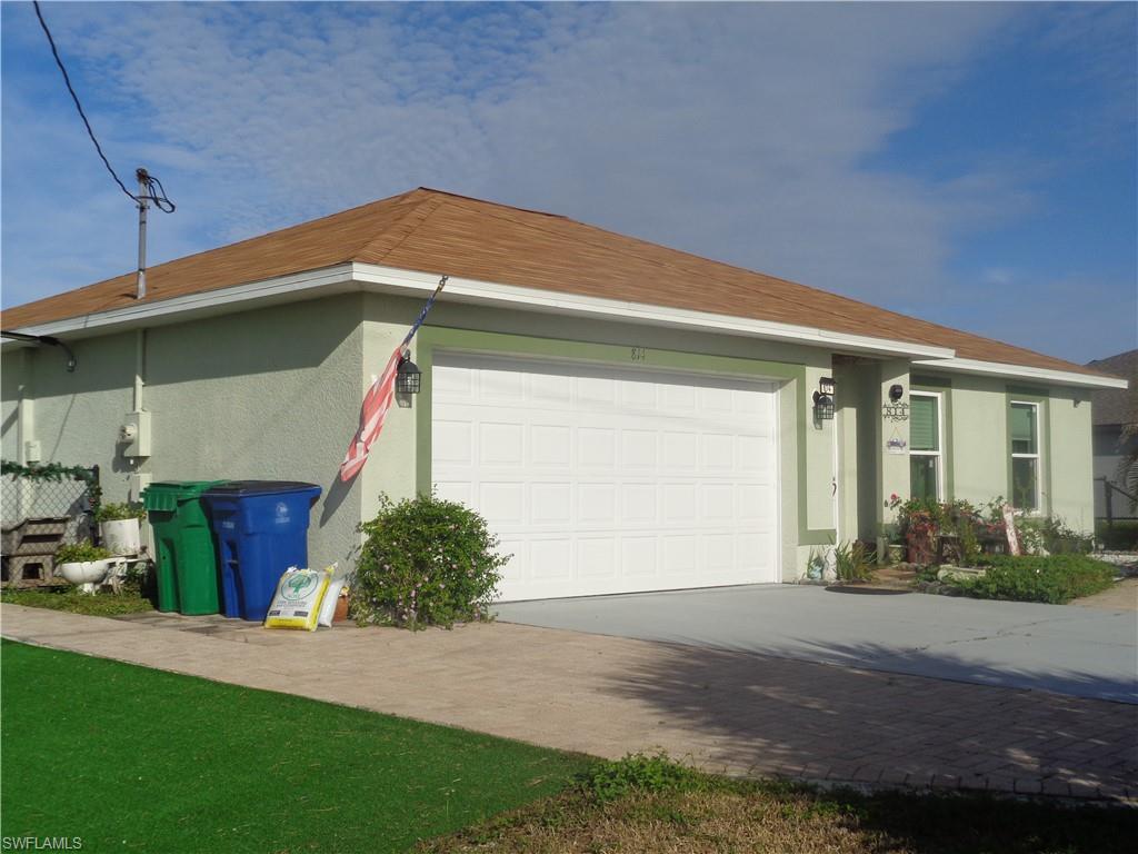 View of home's exterior featuring stucco siding, driveway, and a garage