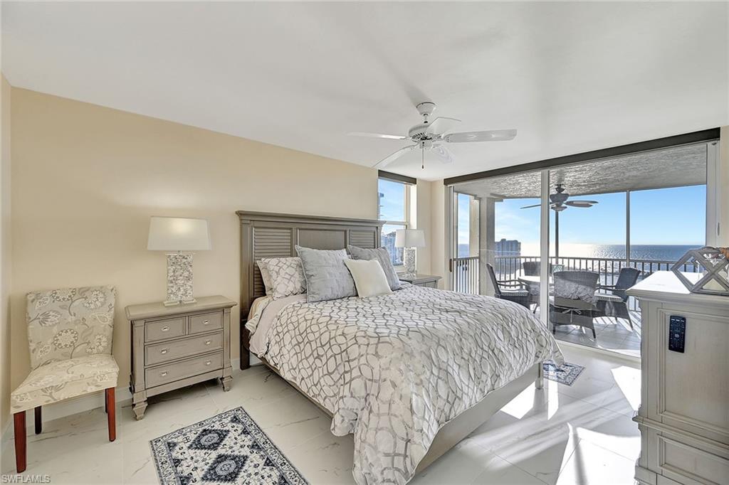 Primary Bedroom with sliding glass doors to Screened Lanai