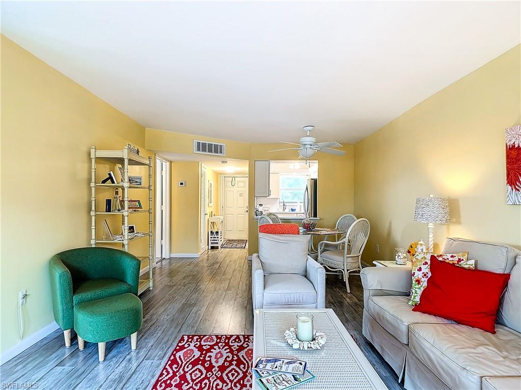 Living room featuring ceiling fan and hardwood / wood-style floors