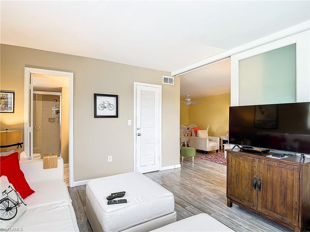 Living room featuring ceiling fan and light wood-type flooring