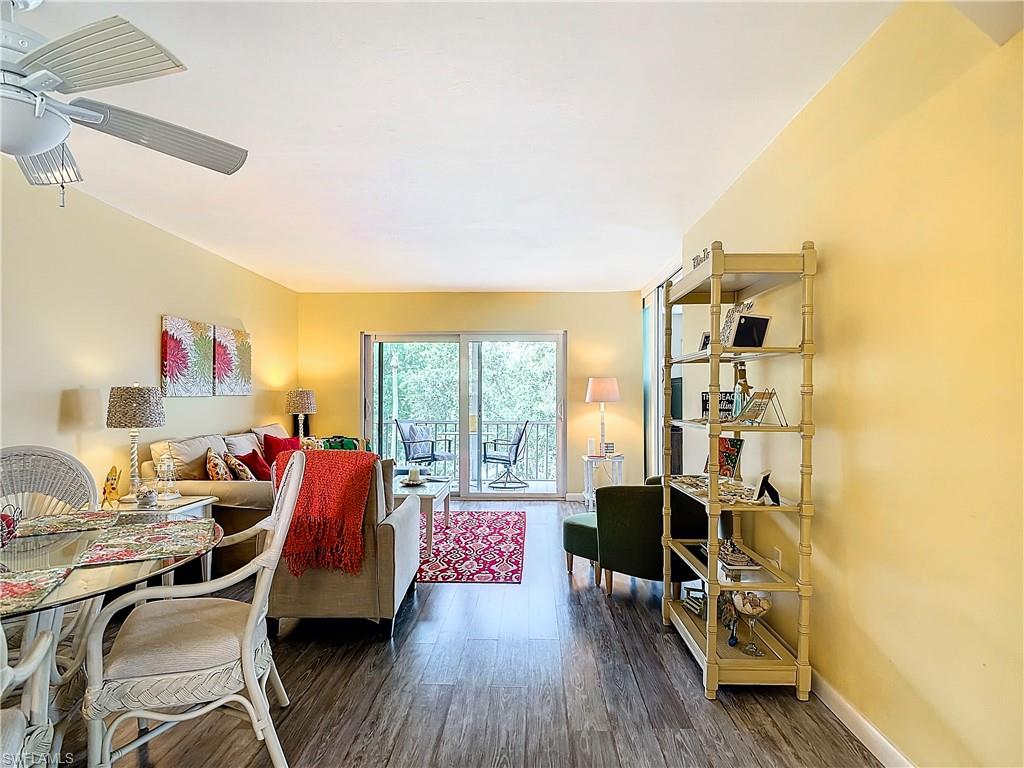 Living room with hardwood / wood-style flooring and ceiling fan