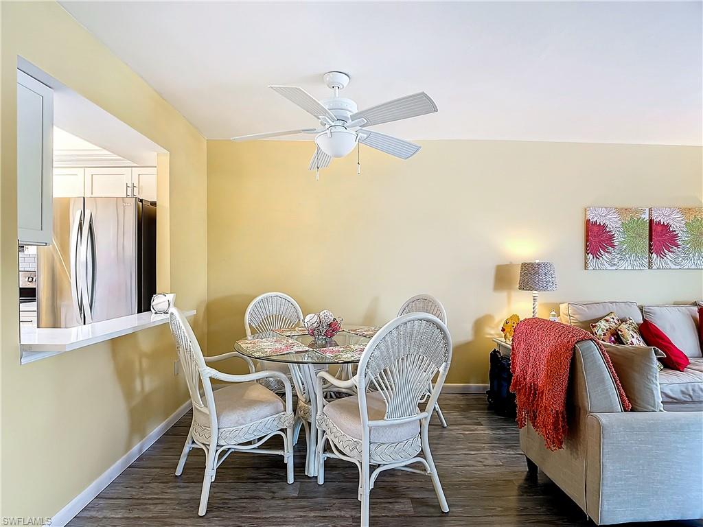 Dining area featuring ceiling fan and dark wood-type flooring