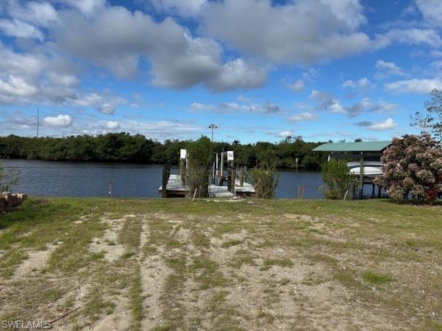Dock area featuring boat lift and a water view