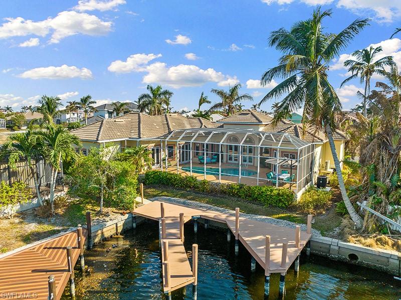 View of dock with a lanai and a water view